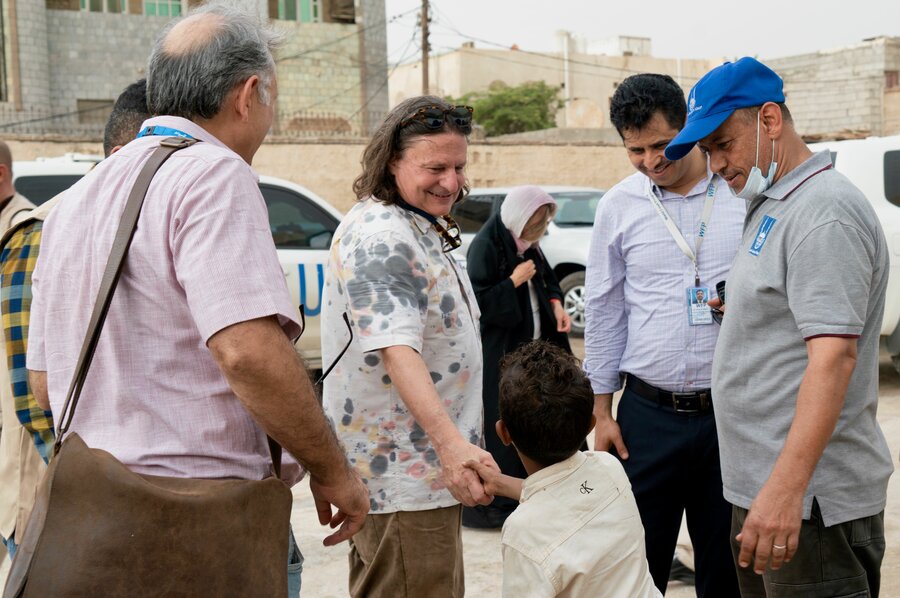 WFP Yemen Country Director Richard Ragan greets a child in Hodeida governorate. Mohammed Awadh